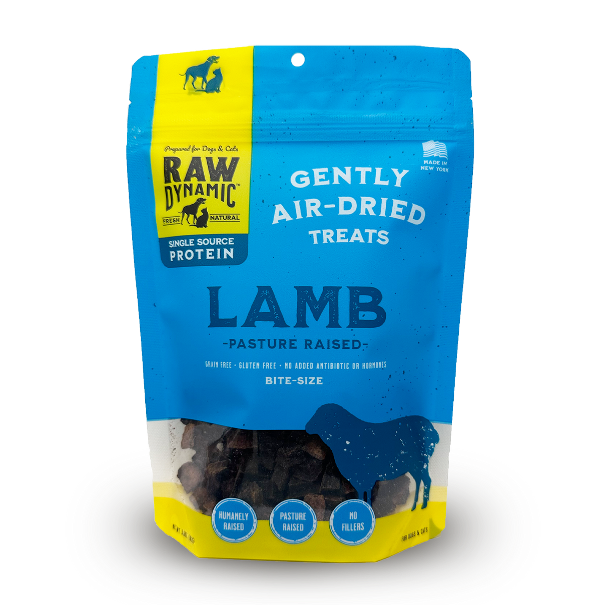 A bag of Raw Dynamic air-dried lamb treats for dogs, featuring bright blue and yellow colors, labeled "pasture raised","bite size" and "no fillers."