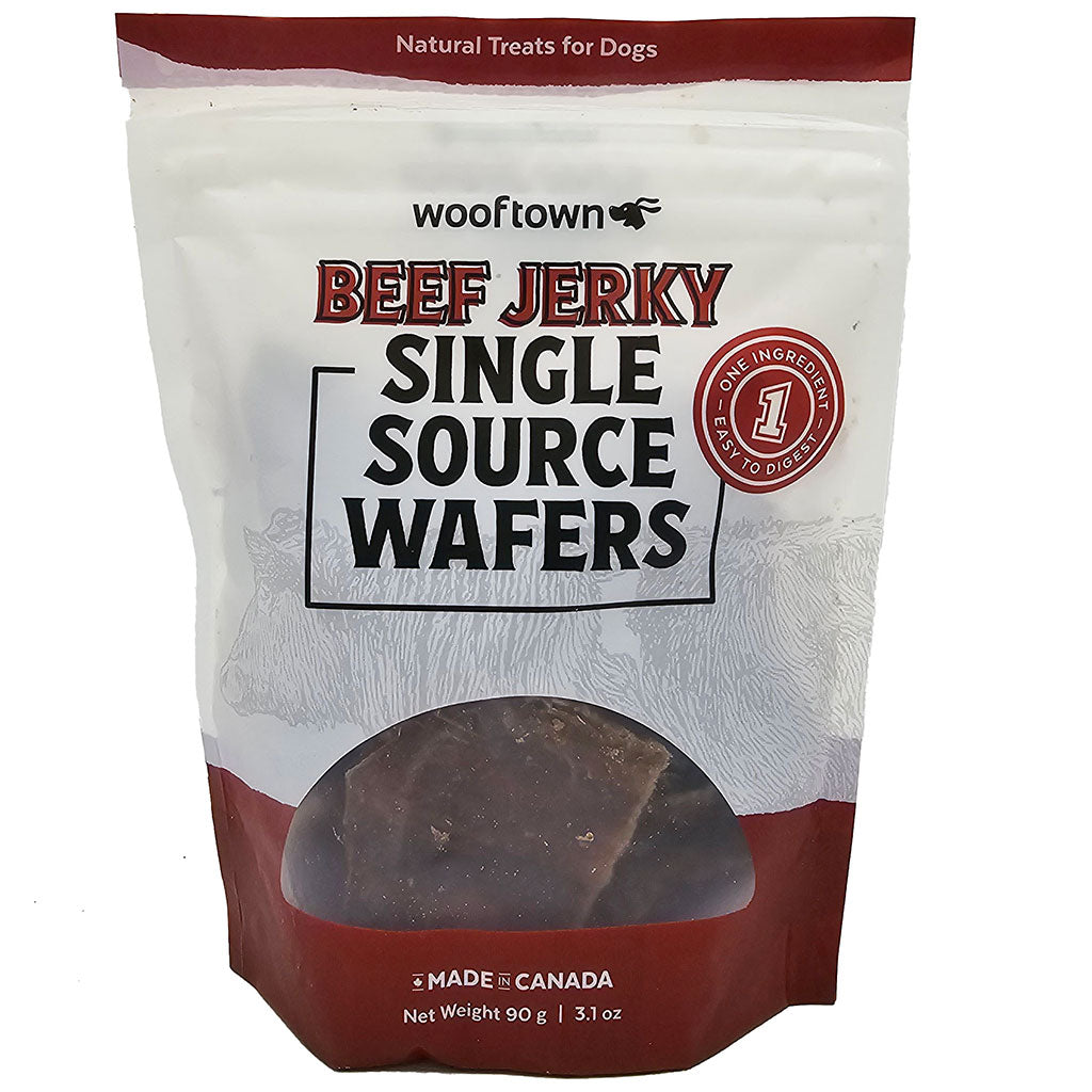 A package of Wooftown beef jerky dog treats, labeled "Single Source Wafers," featuring a red and white design and made in Canada.