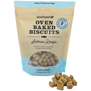 Bag of Wooftown Oven Baked Biscuits in Salmon Recipe, featuring ancient grains and superfoods, with some biscuits beside it.