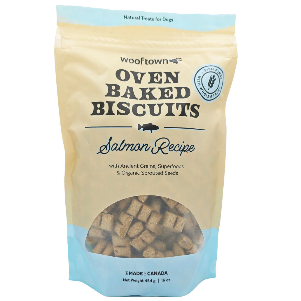 A bag of Wooftown oven-baked dog biscuits with a salmon recipe, featuring ancient grains and superfoods, labeled as natural treats.